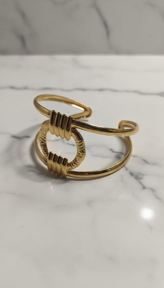 Elegant Gold-Tone Open Cuff Bracelet with Textured Circular Center Design